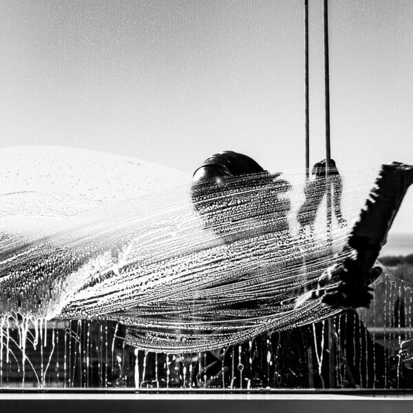 Silhouette of a window cleaner in Buenos Aires captured in black and white.